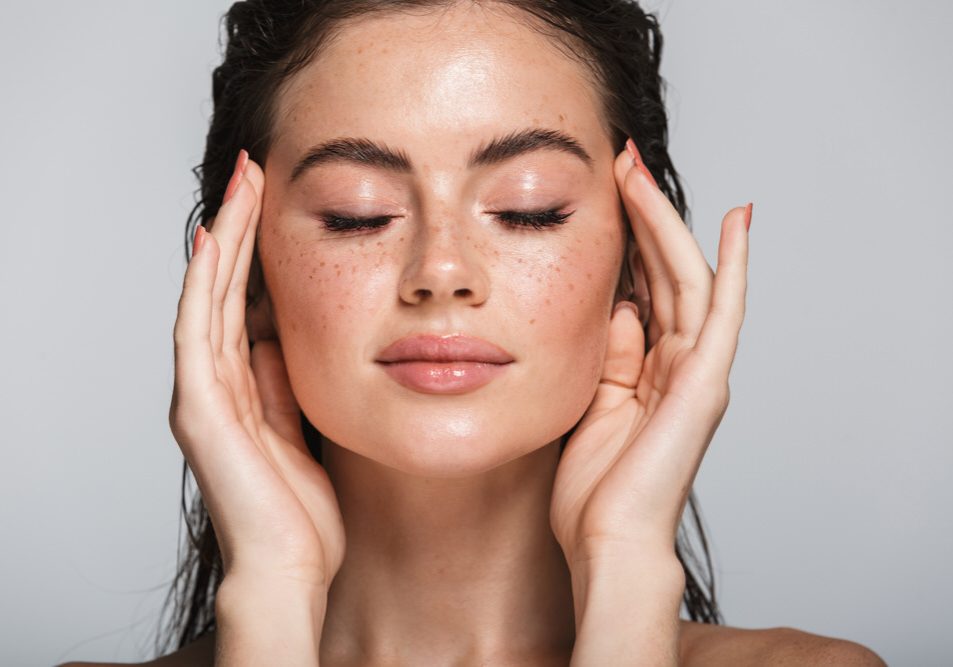 Female touching her temples with eyes closed